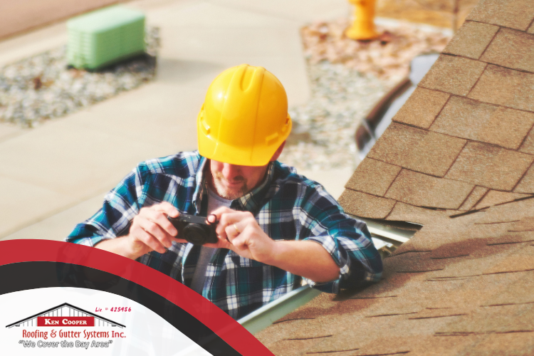 Professional Sausalito Roofing Company technician inspecting a roof for autumn preparedness.