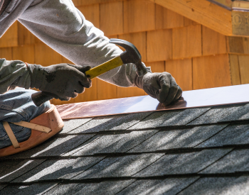 Roof repair in progress on a Novato home during summer